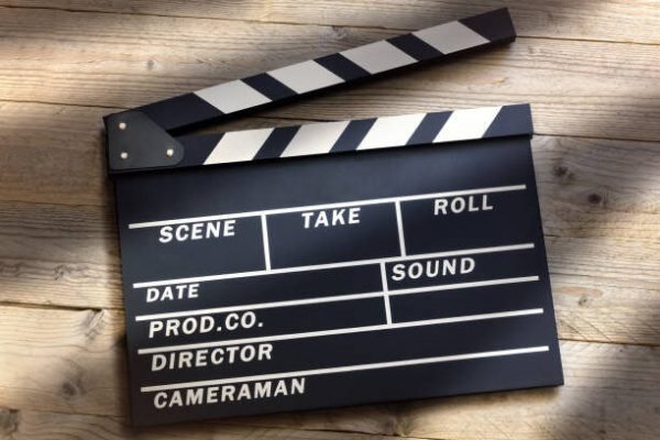 Film slate or movie clapper board on wood background